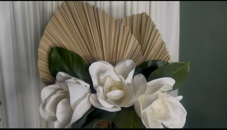 Funeral inspired tablescape with palm fronds and magnolia flowers