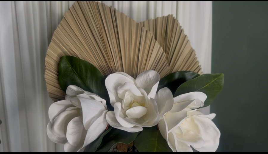 Funeral inspired tablescape with palm fronds and magnolia flowers