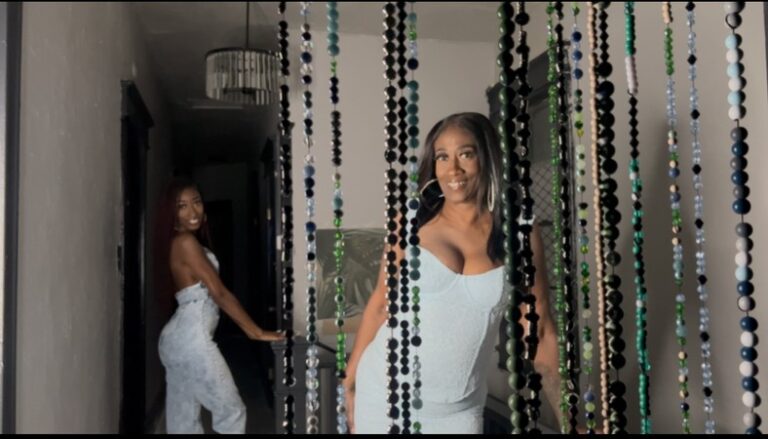 Antonia and Valerie in a hallway with beaded curtain