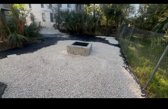Backyard with limestone rock landscaping in progress